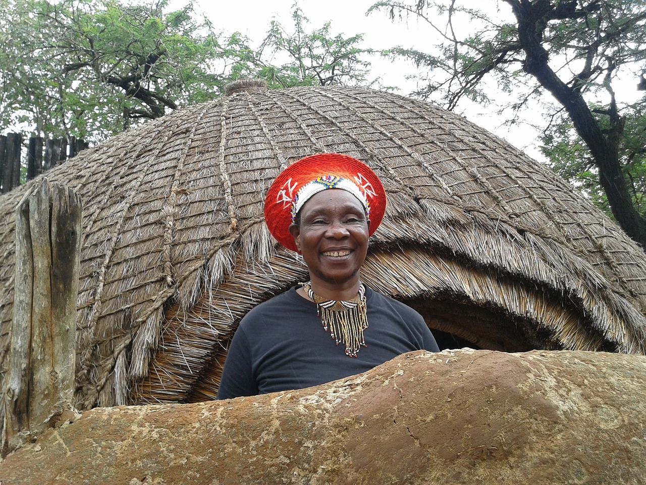 A women adorned in african symbolic accessories
